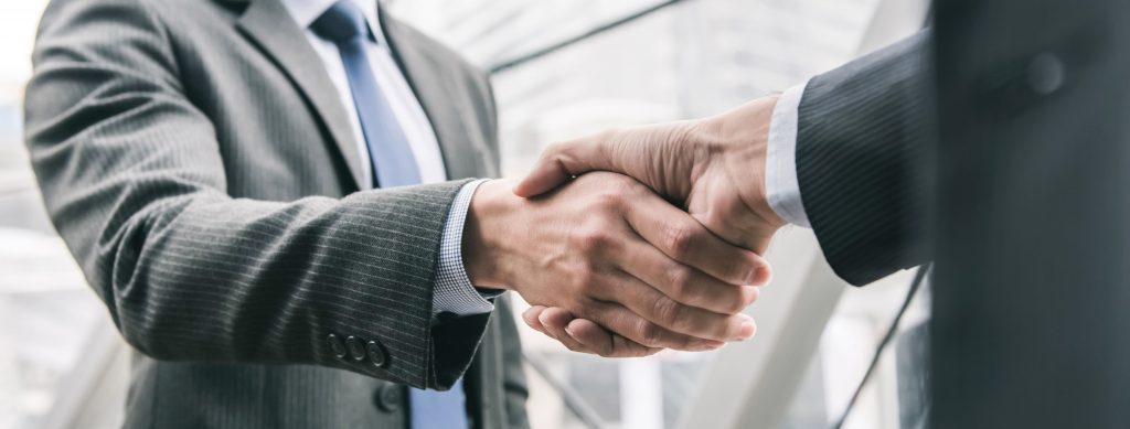 businessman-making-handshake-with-partner